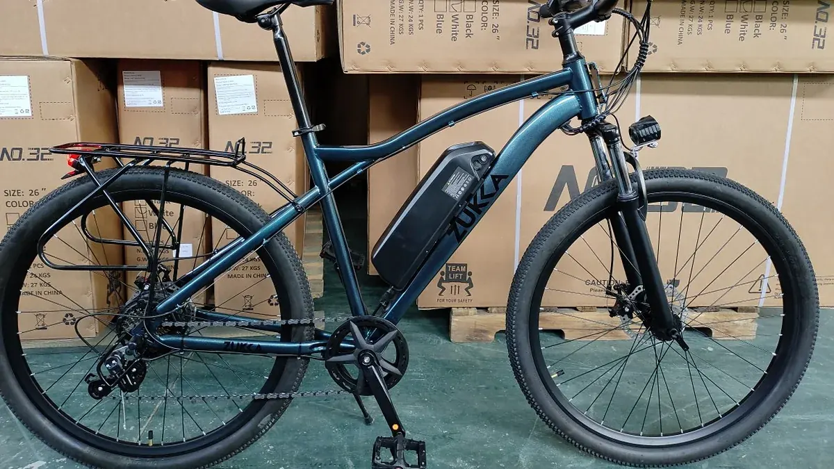 An e-bike with a frame-mounted battery in front of shipping boxes