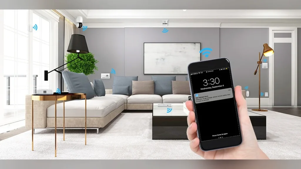 Hand holding a phone showing a smoke alarm alert in a smart living room